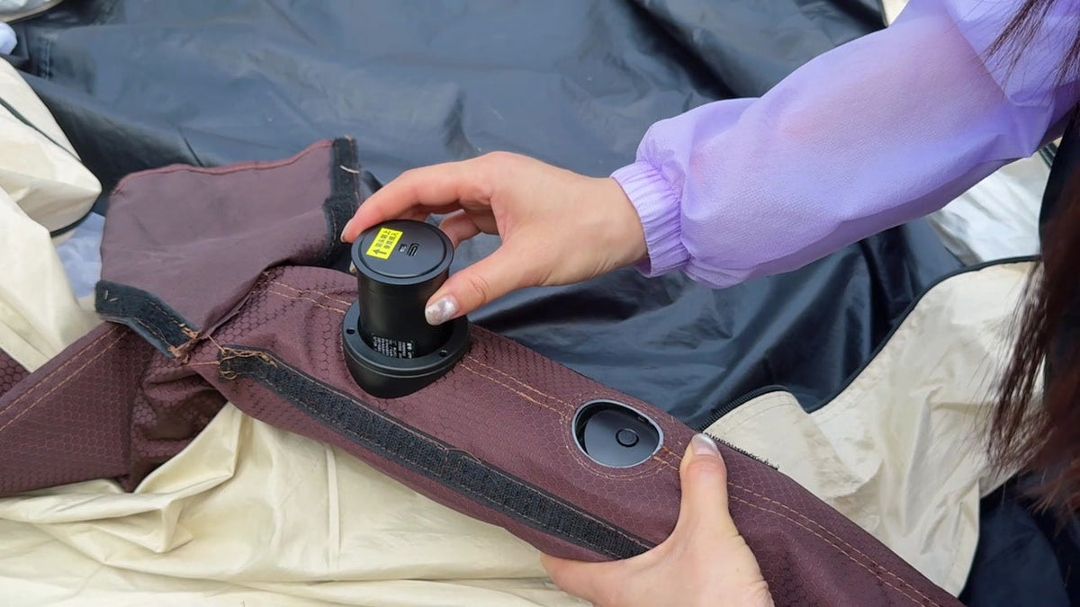 Camper using the built-in pump to inflate the LINKSOLAR tent body