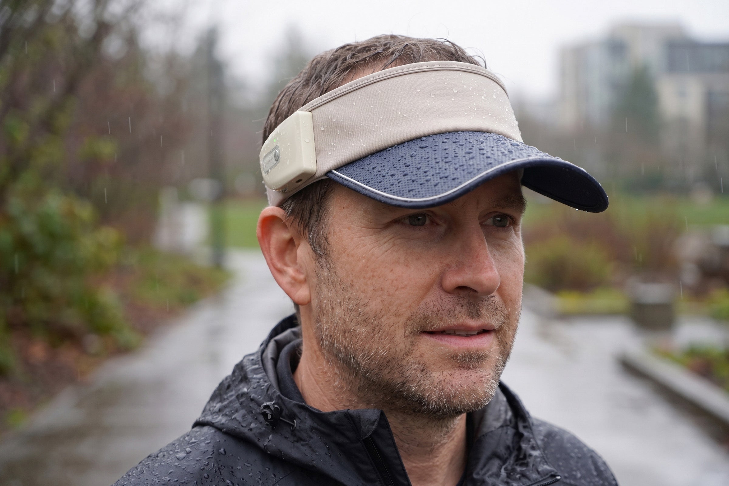 LINKSOLAR Solar Audio Visor worn outdoors in rain to illustrate IPX5 splash resistance