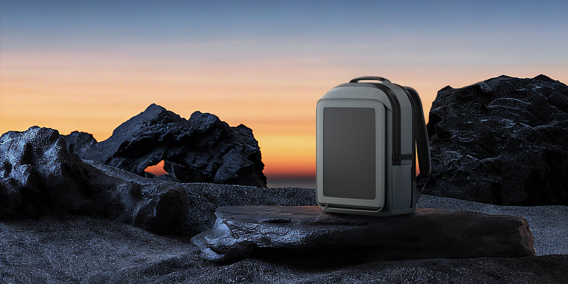 Closed LINKSOLAR PT-B-30W solar backpack standing on dark rocks at sunset