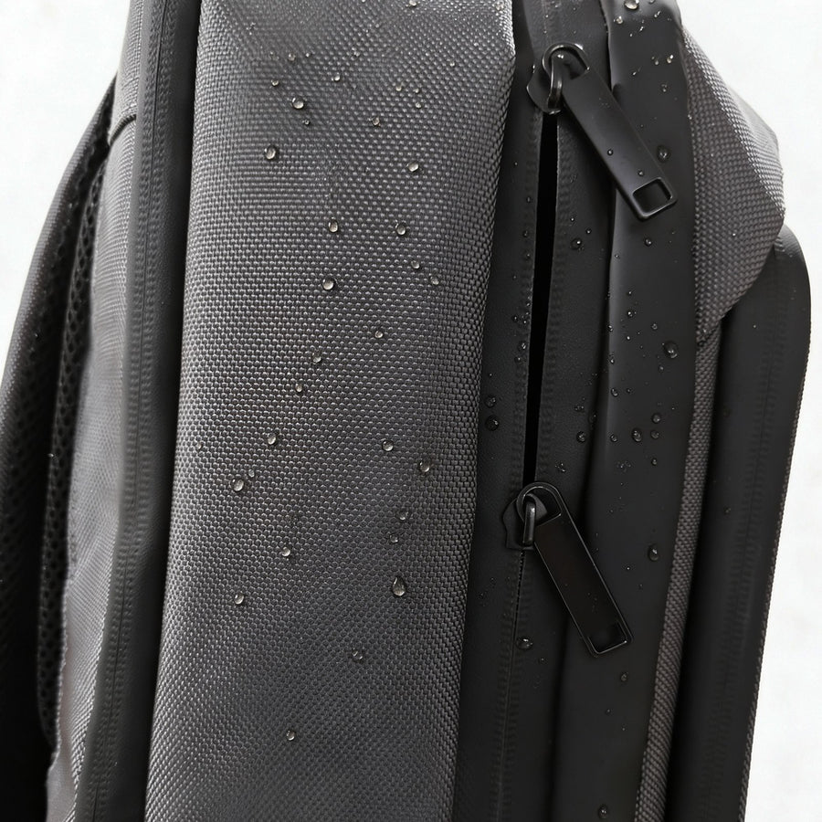 Close-up of water beading on the YKK water-resistant zippers and fabric
